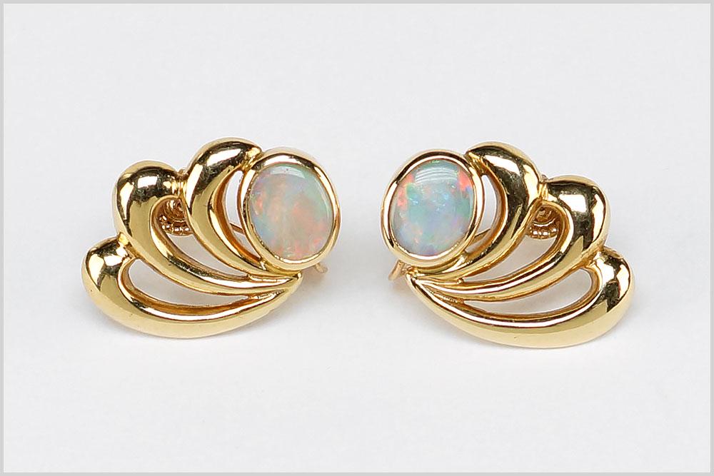 A Pair of Opal Earrings.: A Pair of Opal Earrings. 14 karat yellow gold screwback earrings each contains one bezel set oval opal Wt: 10.6 grams