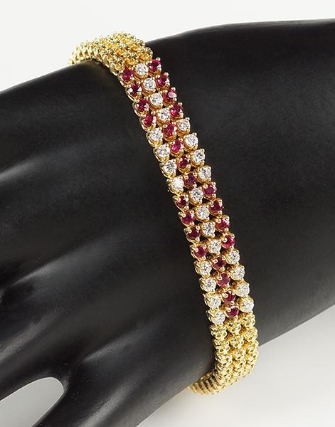 A Ruby & Diamond Bracelet.: A Ruby & Diamond Bracelet. 18 karat yellow gold bracelet contains 24 prong set round brilliant diamonds which total approximately 1.20 carats. 24 prong set round rubies total approximately 1.20 carats