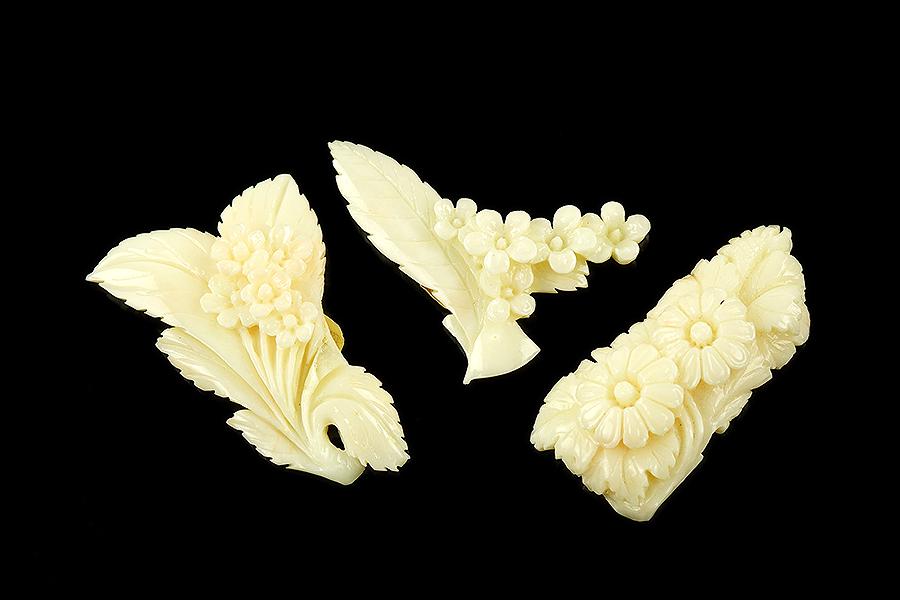 Three Pieces of Angel Skin Coral.: Three Pieces of Angel Skin Coral. Carved angel skin coral pieces decorated with flowers and leaves Largest: 2.25" x 1.5"