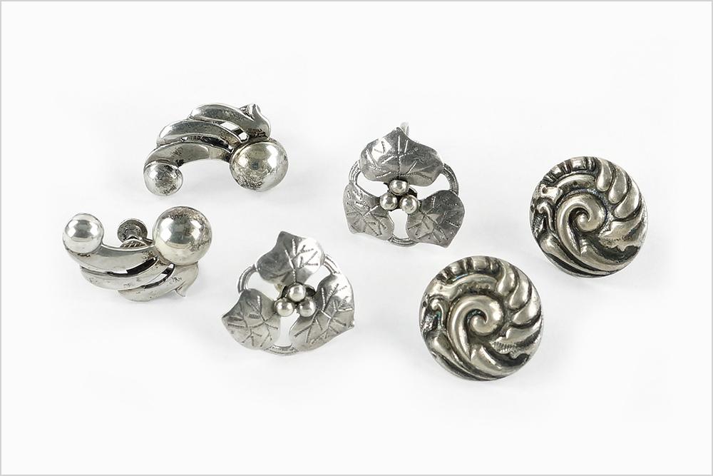 A Pair of Kalo Sterling Silver Screwback Earrings.: A Pair of Kalo Sterling Silver Screwback Earrings. Half silver ball with waves extending, ending in a smaller halved ball. Together with two pairs of sterling silver screwback earrings