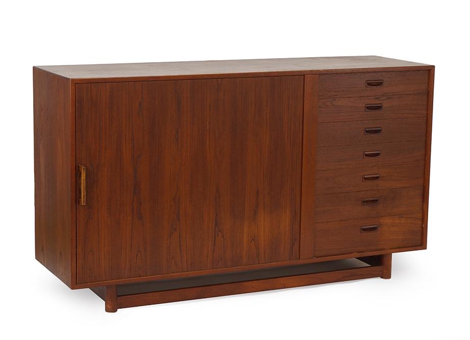 A Mid-Century Credenza.: A Mid-Century Credenza. Bearing a sliding door at left and a stack of drawers at right 36" x 63" x 19"