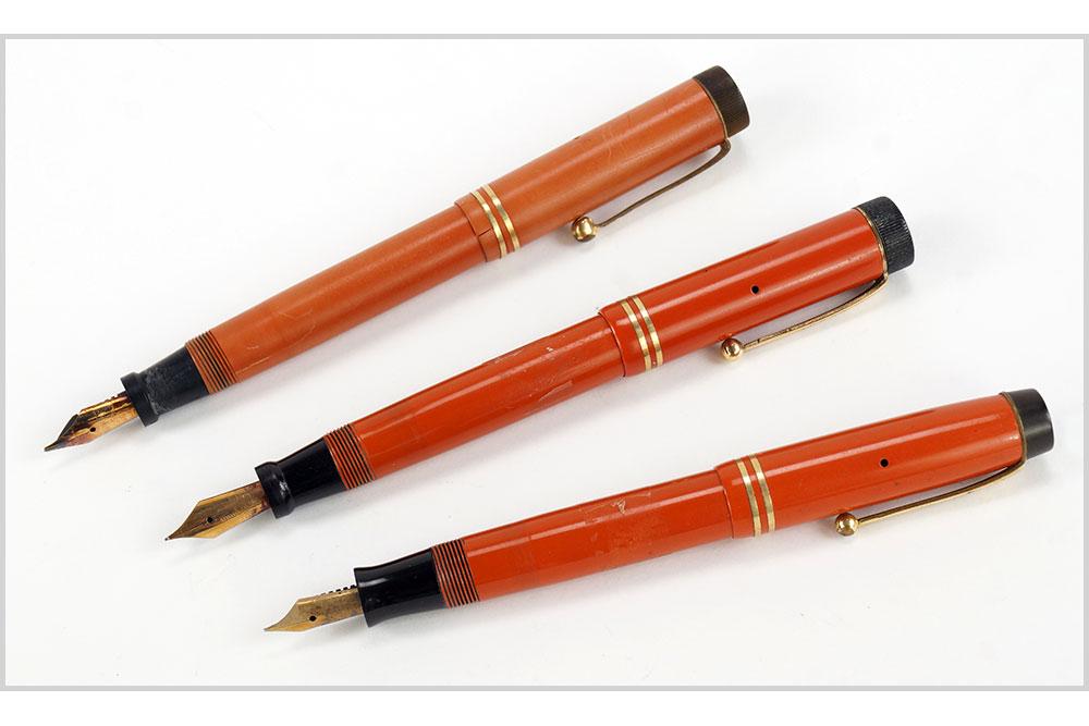 Three Parker Duofold Orange Fountain Pens. (1 of 9)