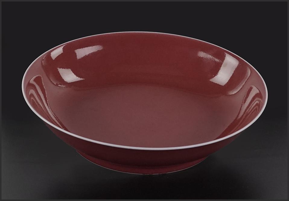 A Chinese Sang de Boeuf Porcelain Dish.: A Chinese Sang de Boeuf Porcelain Dish. Bearing an underglaze blue six-character mark within double blue rings on the underside 1.75" x 7.5"