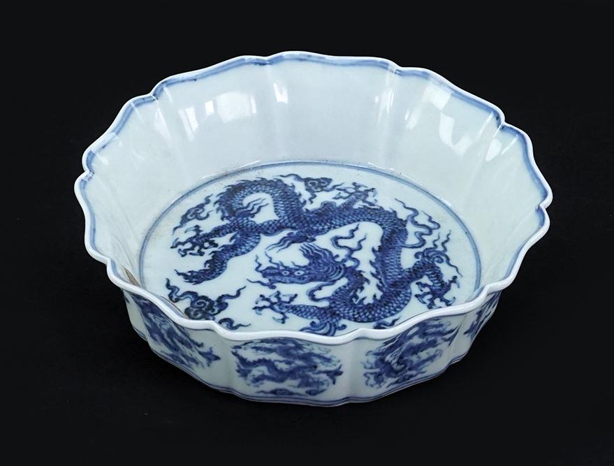 A Chinese Blue and White Porcelain: A Chinese Blue and White Porcelain 'Dragon' Bowl. Bearing a lobed/foliate form perimeter and decorated with dragons to the bed, outer perimeter, and underside. Unmarked 1.75" x 6.75"