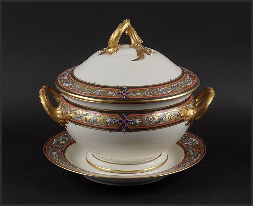 A KPM Porcelain Tureen and Underplate.: A KPM Porcelain Tureen and Underplate. Gilt and painted porcelain tureen with Rococo style handle and a coordinating underplate (diameter: 12.5") Tureen: 12" x 13 1/2" x 10"