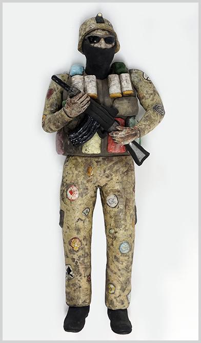 Stephen Braun (American, Contemporary) Title Unknown.: Stephen Braun (American, Contemporary) Title Unknown. Painted and glazed raku pottery two-piece wall mount sculpture depicting a make figure in uniform holding an assault rifle Height: 29"