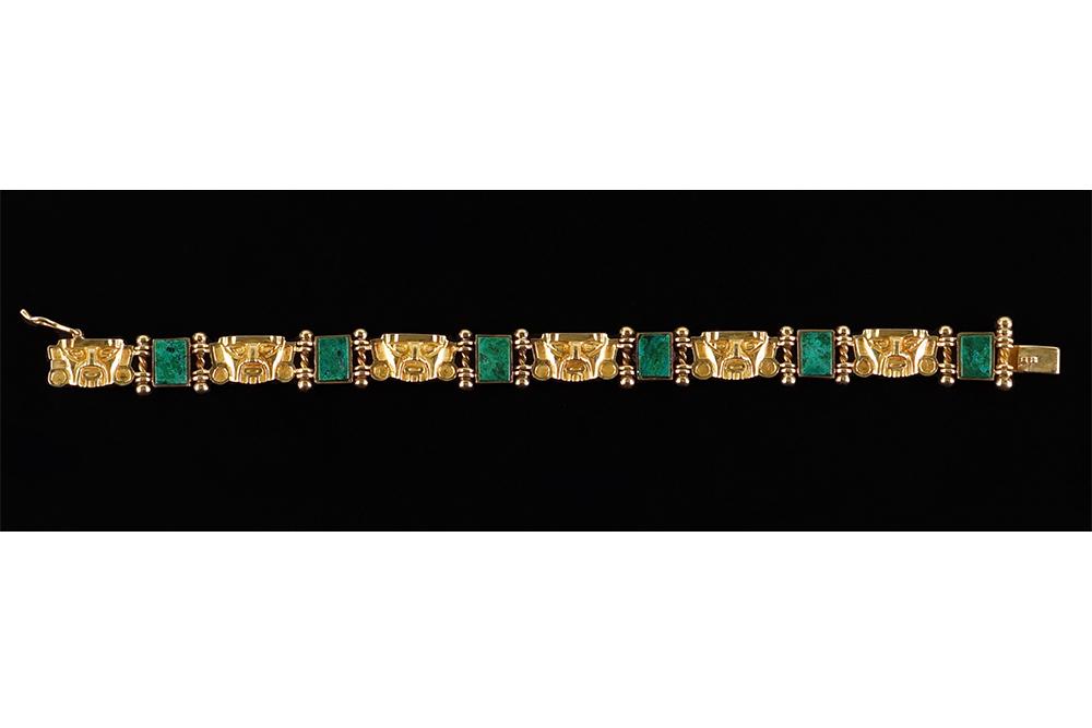 An 18 Karat Yellow Gold Bracelet.: An 18 Karat Yellow Gold Bracelet. Alternating yellow gold mask links and compressed azurite malachite links Length: 7 1/4" Wt: 30.7 grams
