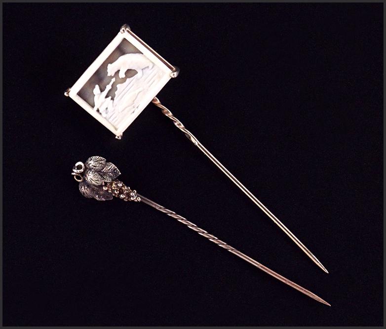 Two 14 Karat Gold Stick Pins.: Two 14 Karat Gold Stick Pins. Comprising a grape bunch stick pin and a carved bone stick pin depicting an Inuit figure attacking a polar bear with a whale swimming below Wt of both: 7.0 grams