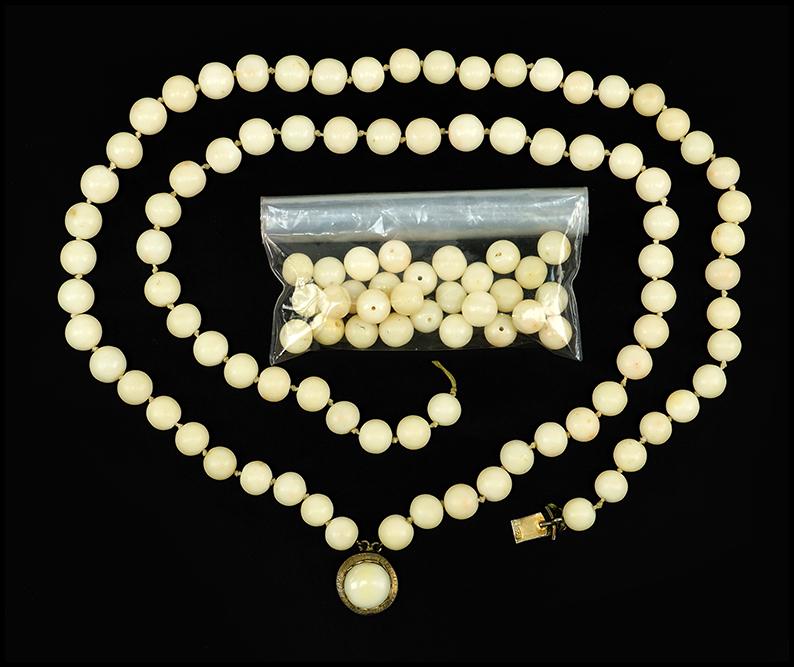 An Angel Skin Coral Necklace.: An Angel Skin Coral Necklace. Double strand angel skin coral beads are 8mm. Clasp is gilt .800 silver with an angel skin coral button. Second strand is broken but beads are present for restringing Sho