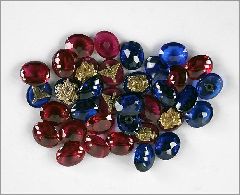 A Collection of Unmounted Synthetic Spinels and: A Collection of Unmounted Synthetic Spinels and Sapphires. Including ten which are mounted with 10 karat yellow gold emblems