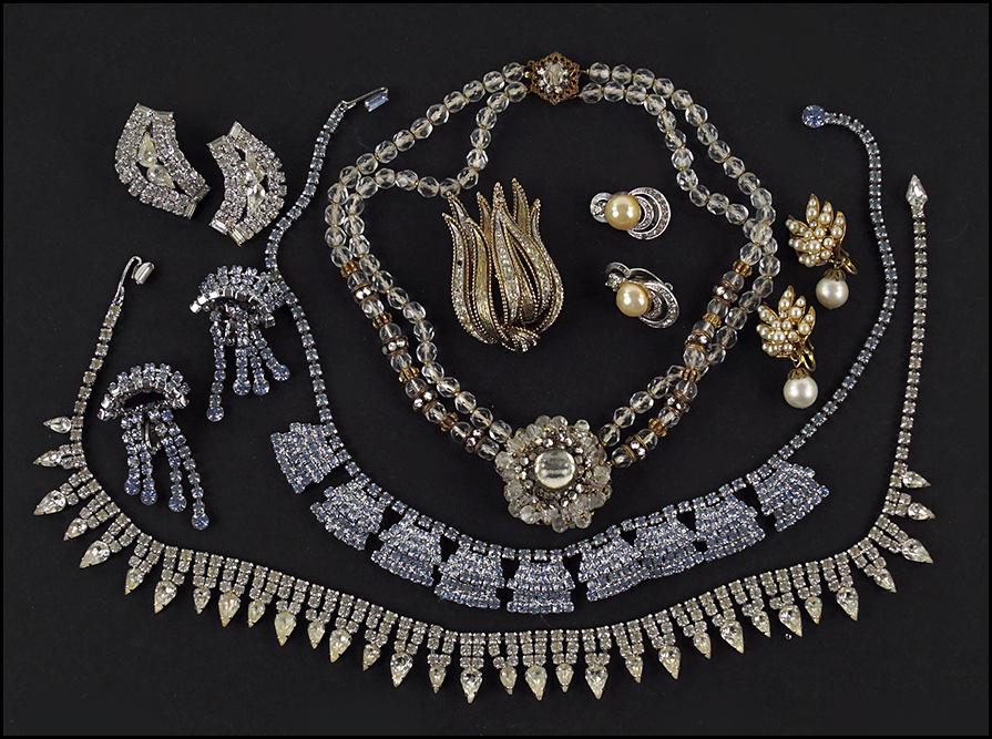 A Kramer White Rhinestone Demi-Parure.: A Kramer White Rhinestone Demi-Parure. Comprising a necklace and pair of earclips. Together with a Kramer blue rhinestone necklace and pair of earclips (unsigned), a Miriam Haskell two strand necklace