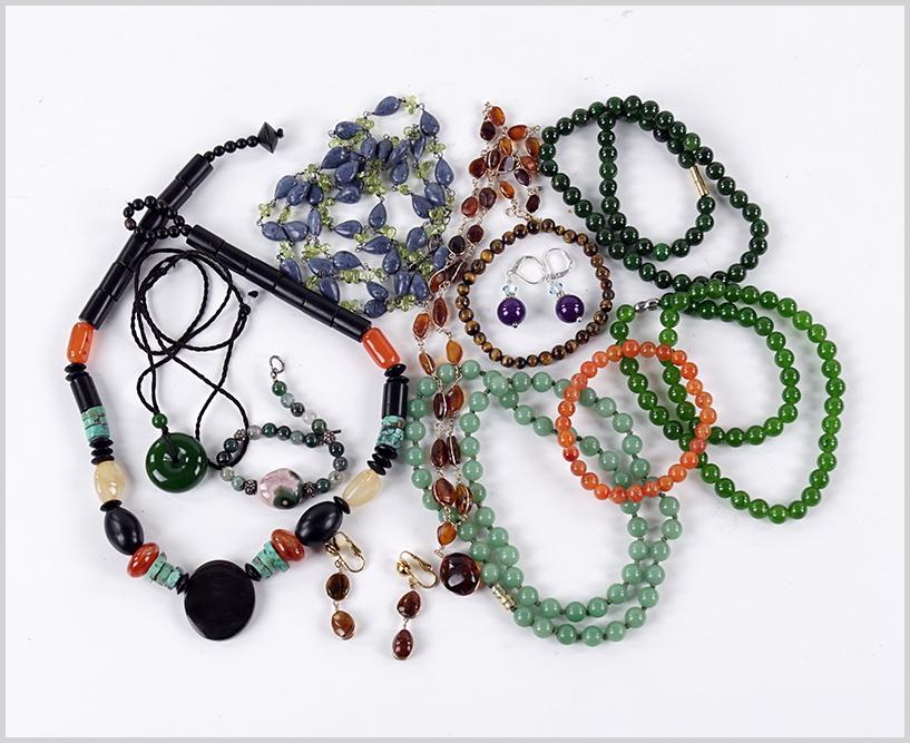 A Collection of Semi-Precious Stone Jewelry.: A Collection of Semi-Precious Stone Jewelry. Comprising a blue coral and peridot necklace, three quartz bead necklaces, an amber bead necklace with coordinating earrings, a pair of sugilite drop earri