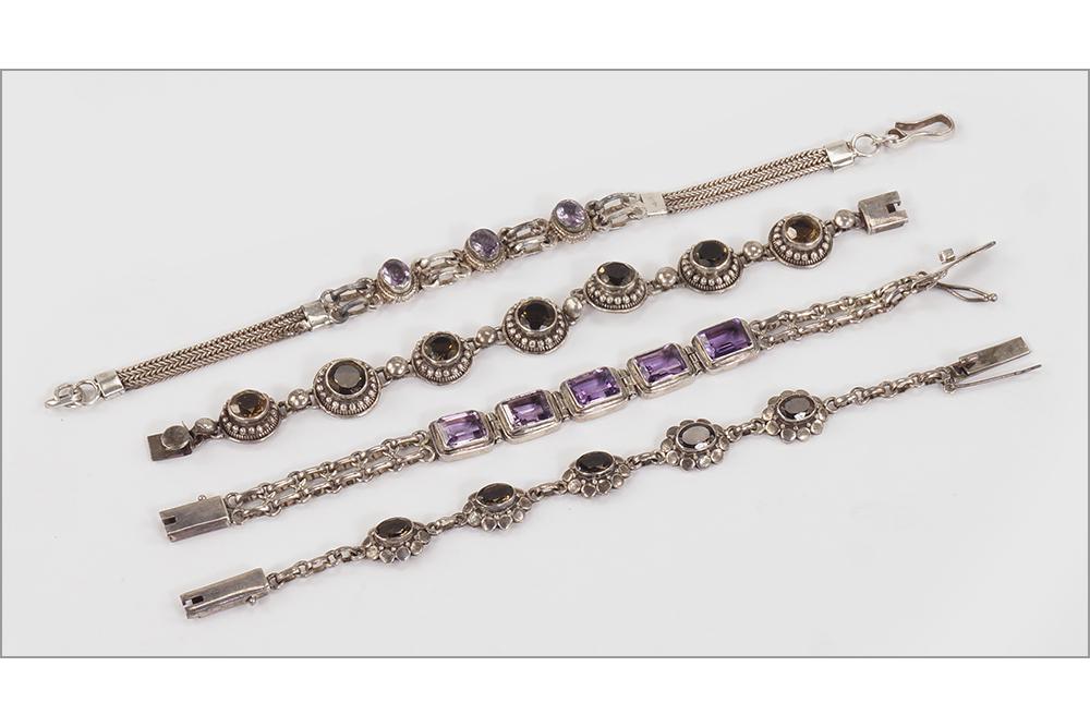 Four Sterling Silver Link Bracelets.: Four Sterling Silver Link Bracelets. Two are mounted with smoky quartz and two are mounted with amethyst Wt of all: 86.3 grams