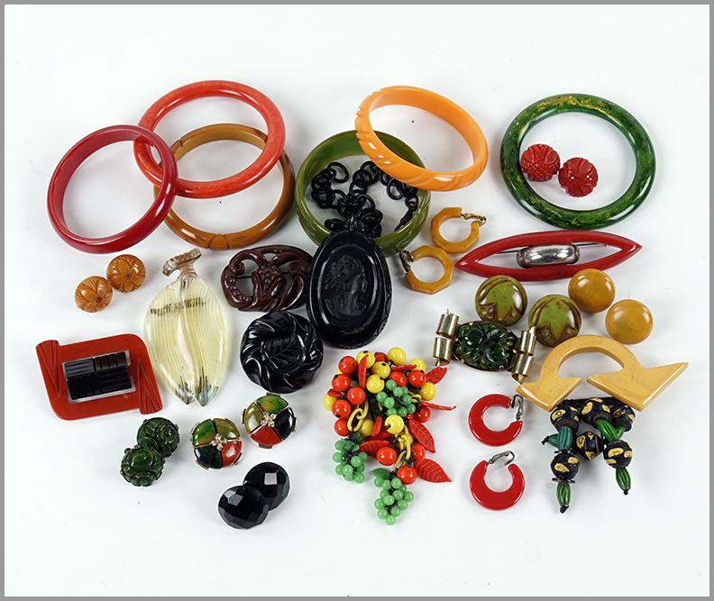 A Collection of Plastic Jewelry.: A Collection of Plastic Jewelry. Comprising bangle bracelets, earrings, one necklace and brooches. Together with a pair of bakelite earrings and one bakelite brooch