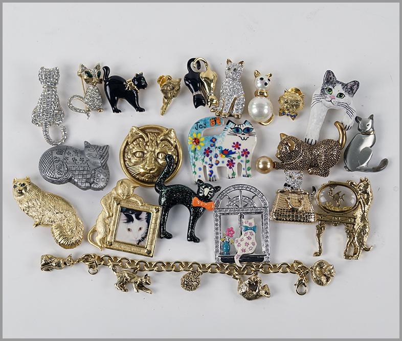 A Collection of Cat Brooches.: A Collection of Cat Brooches. Signed brooches by Monet, Bob Mackie, Sphinx, Carolee and others. Together with an MFA cat charm bracelet