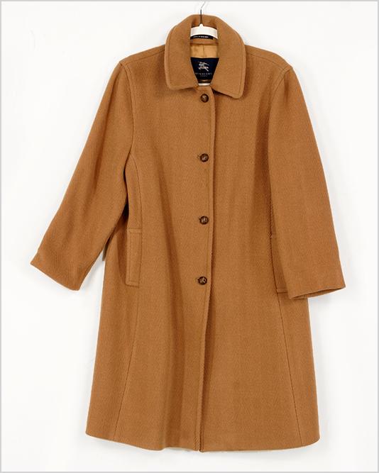 A Burberry Coat.: A Burberry Coat. Wool and polyester blend herringbone pattern coat with four leather buttons Size: 12
