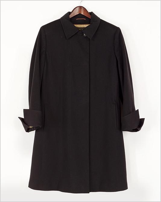 A Loro Piana Coat.: A Loro Piana Coat. Black cashmere coat with a quilted lining and turn up cuffs Size: 46