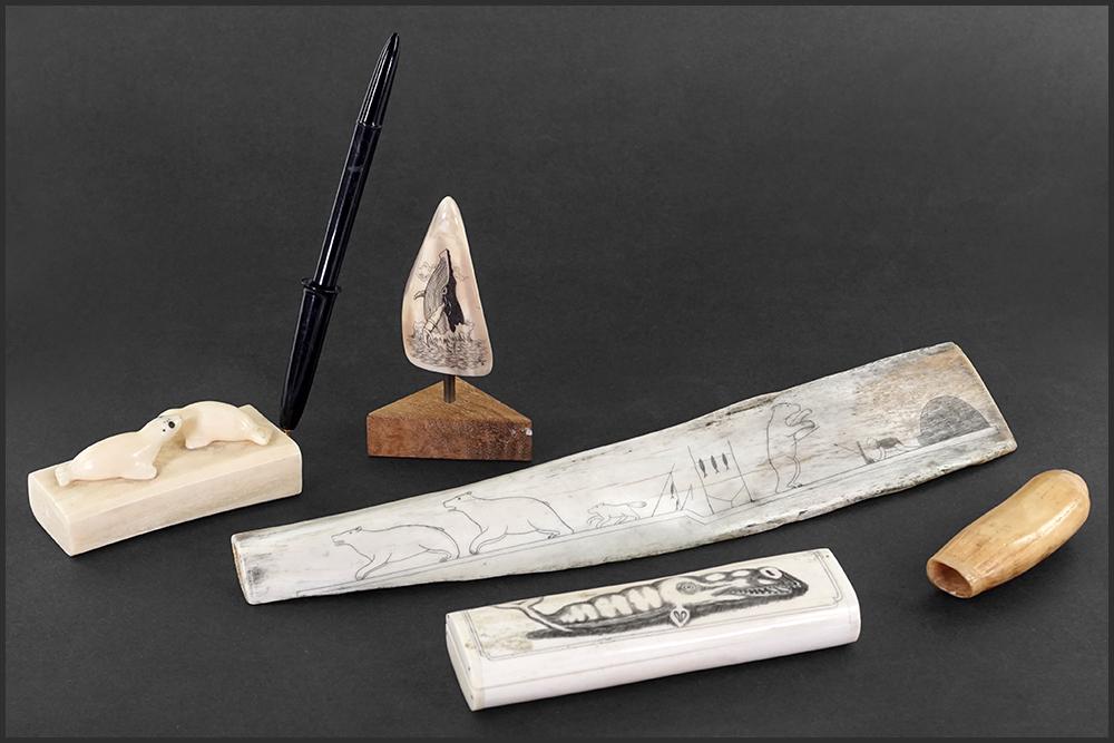 A Collection of Scrimshaw.: A Collection of Scrimshaw. Including a carved bone box, a carved bone pen stand, and a carved bone depicting a figure hunting animals. Together with a scrimshaw tooth and another tooth Longest: 12.75"
