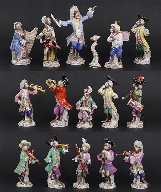 A 20th Century Meissen Porcelain Monkey Band.: A 20th Century Meissen Porcelain Monkey Band. Comprising a conductor, a music stand, a singing figure holding a book of sheet music, a drummer (tail and drum stick chipped), a figure with two drums on