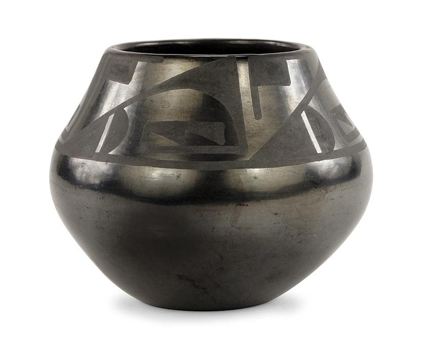A San Ildefonoso Maria & Julian Martinez Jar.: A San Ildefonoso Maria & Julian Martinez Jar. Blackware jar with repeating geometric decoration around the upper half. Underside is signed "Marie + Julian" 4.25" x 5"