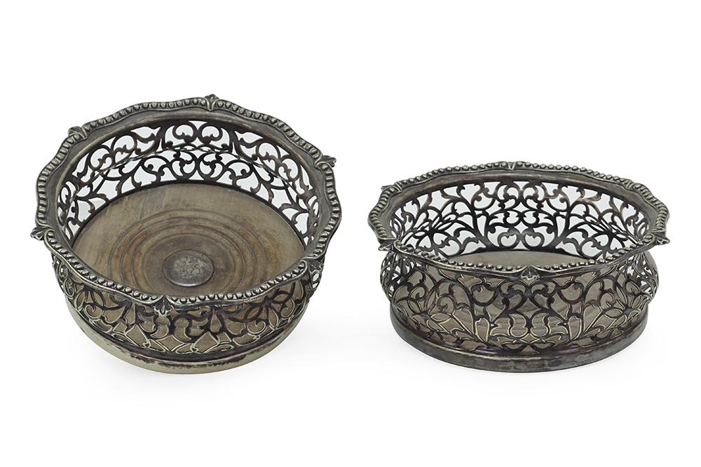 A Pair of English Wine Coasters.: A Pair of English Wine Coasters. Filigree silverplate coasters with wood bases and inset engraved silver centers 2 1/2" x 6 1/4"