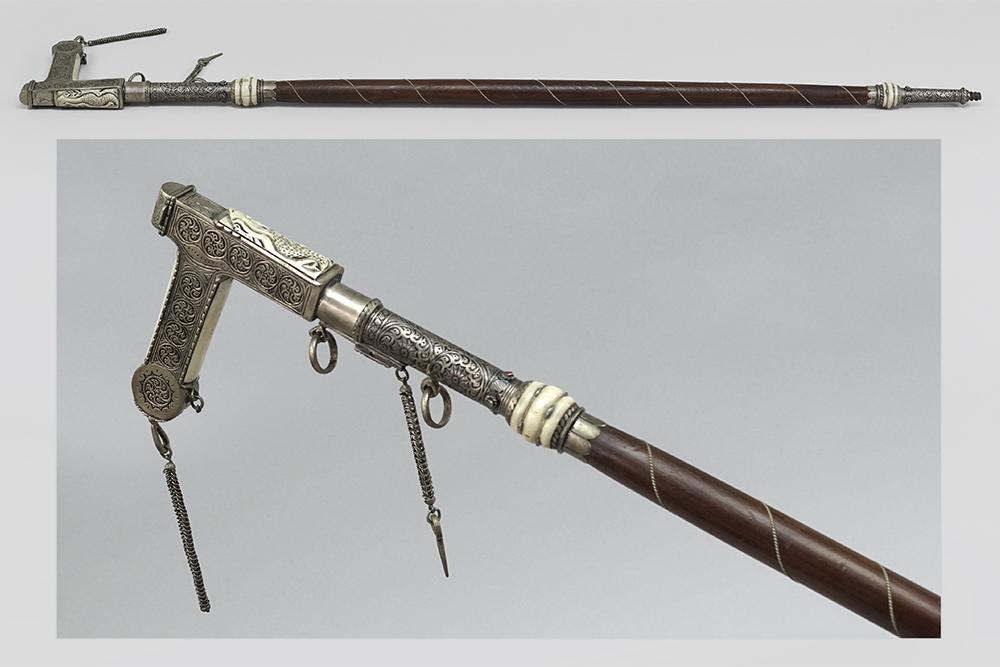 A Sword Cane.: A Sword Cane. Wood cane with a silverplate handle decorated with Niello style enamel and carved bone inserts. Handle is mounted with a 10 1/2" blade Length: 38 1/2"