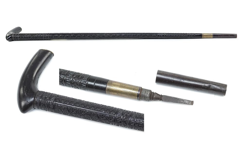 An Ebony Walking Stick.: An Ebony Walking Stick. Carved wood walking stick inlaid with bone at the handle and along the shaft Length: 48"