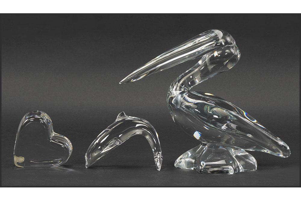 A Daum Crystal Pelican.: A Daum Crystal Pelican. Together with a Baccarat crystal dolphin and a Baccarat crystal heart, all signed Height: 8 1/4"
