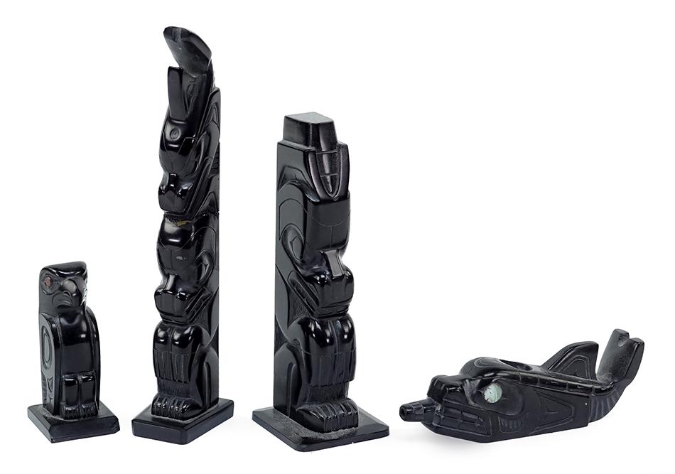 Denny Dixon (Haida, B. 1944) Three Argillite Carvings.: Denny Dixon (Haida, B. 1944) Three Argillite Carvings. Comprising two totems and a killer whale pipe with abalone eyes. Together with a Norman Russ carved argillite totemic seated eagle (Height: 2 1/2