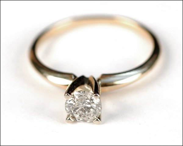 DIAMOND AND FOURTEEN KARAT YELLOW GOLD SOLITAIR: DIAMOND AND FOURTEEN KARAT YELLOW GOLD SOLITAIRE RING. Round brilliant diamond is approximately .50 carat Size 6