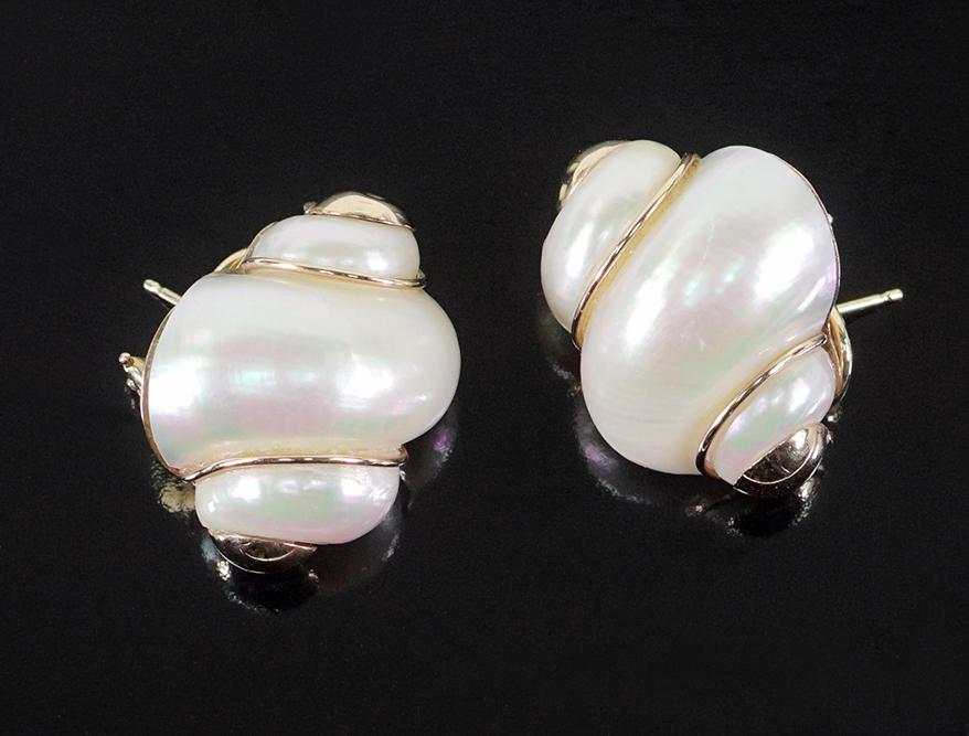A Pair of Maz Turbo Shell Earclips.: A Pair of Maz Turbo Shell Earclips. 14 karat yellow gold clip / post mountings each contain a gold wire wrapped shell with gold caps above and below 1 1/4" x 3/4" Wt: 17.7 grams