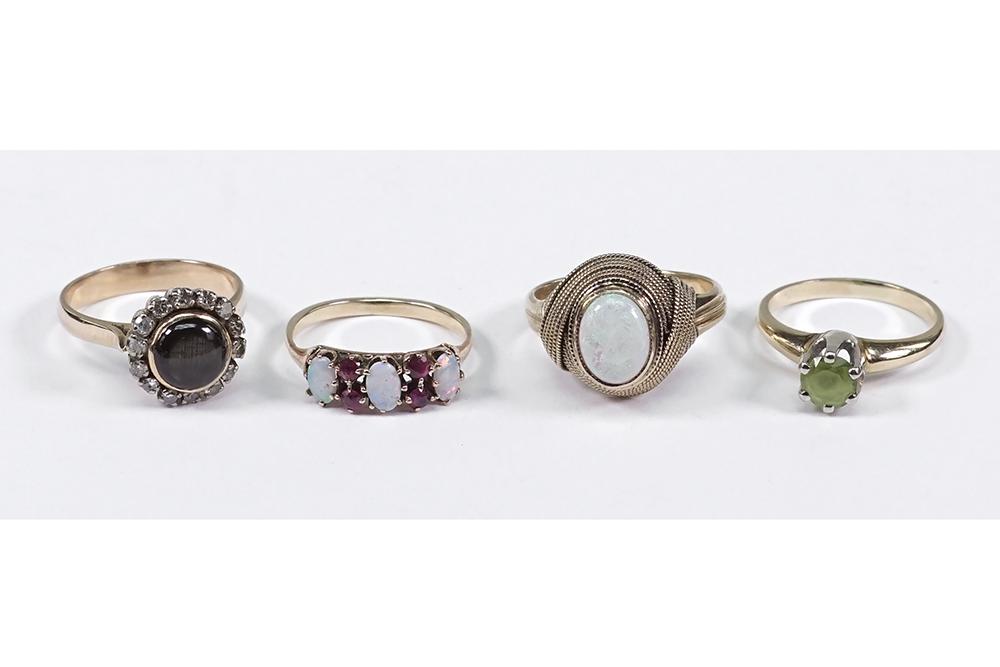 Four 14 Karat Yellow Gold Cocktail Rings.: Four 14 Karat Yellow Gold Cocktail Rings. Comprising a peridot ring, a black star sapphire and diamond ring, an opal ring and a ruby and opal ring Sizes 5 3/4 - 6 3.4 Wt of all: 15 grams