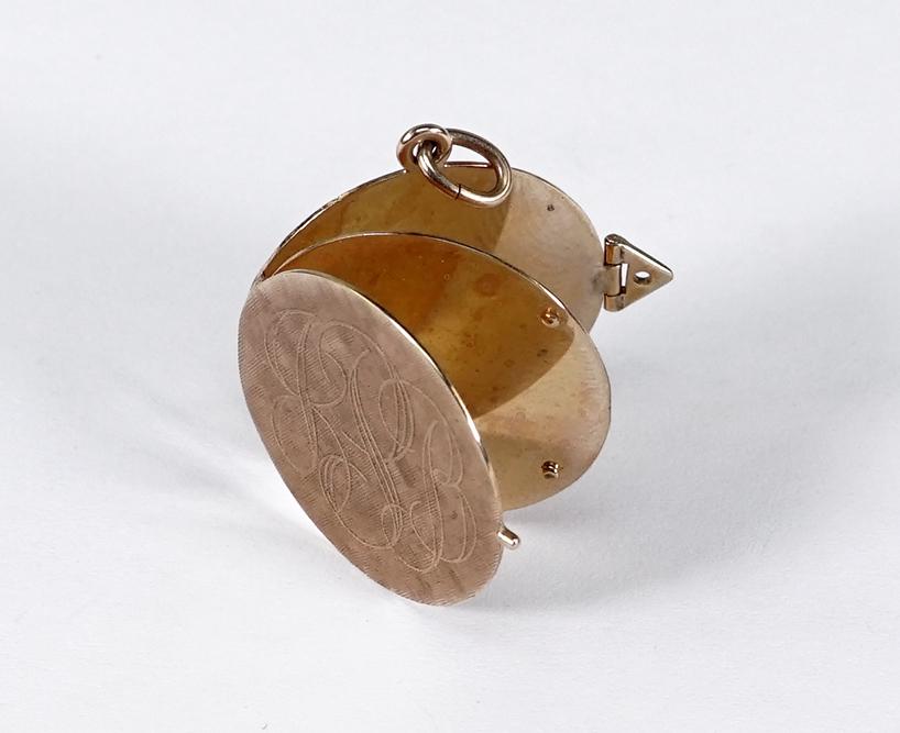 A 14 Karat Yellow Gold Locket Pendant.: A 14 Karat Yellow Gold Locket Pendant. Round pendant opens to reveal a round divider between the front and back flaps. With snap closure to side. Monogrammed "JBP" Wt: 7.9 grams Diameter: 1"
