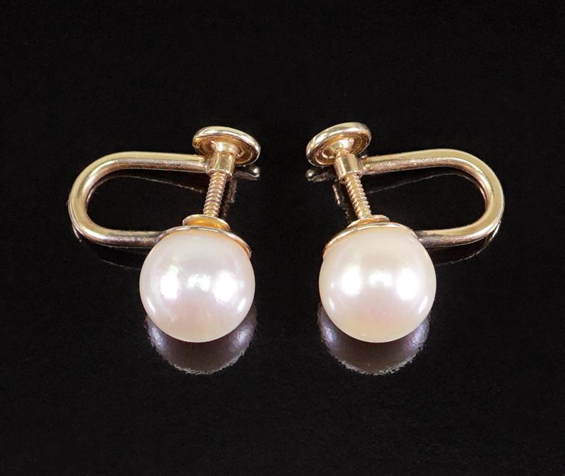 A Pair of Pearl Earrings.: A Pair of Pearl Earrings. 14 karat yellow gold screwback earrings each contain one cultured pearl which is approximately 8.55mm Wt: 3.4 grams