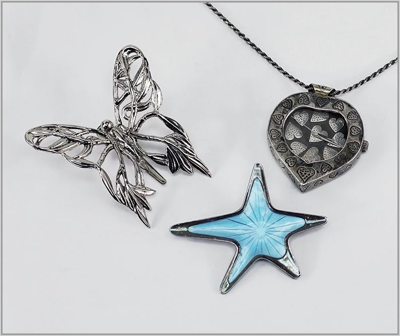 A John Hardy Sterling Silver Watch Pendant Necklace.: A John Hardy Sterling Silver Watch Pendant Necklace. Heart form sterling silver watch pendant with a sterling silver rope necklace length: 35"). Together with a John Hardy butterfly form clip and a Da