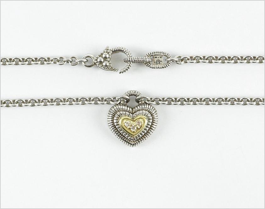 A Judith Ripka Necklace.: A Judith Ripka Necklace. Sterling silver and 18 karat yellow gold heart necklace contains three bead set round brilliant diamonds Length: 17" Wt: 11.4 grams