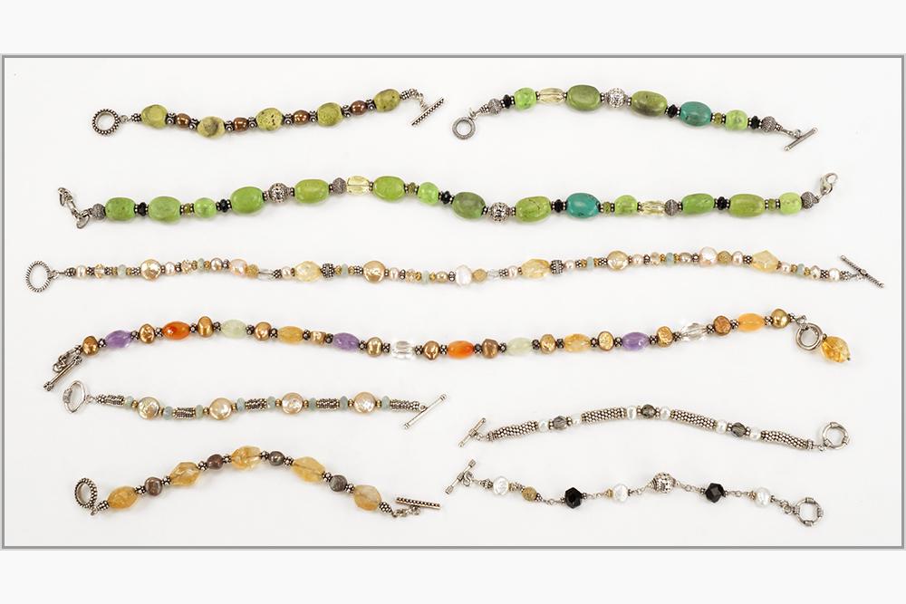 A Collection of Semi-Precious Stone Jewelry.: A Collection of Semi-Precious Stone Jewelry. Comprising a citrine, aquamarine and pearl bracelet and necklace, a gaspeite bracelet and necklace, a citrine, amethyst and carnelian bead necklace and bra