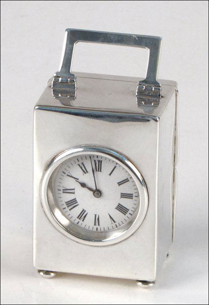 MAPPIN & WEBB STERLING SILVER CARRIAGE CLOCK.: MAPPIN & WEBB STERLING SILVER CARRIAGE CLOCK. With a French movement H: 3.5" W: 1.75" D: 1.5"
