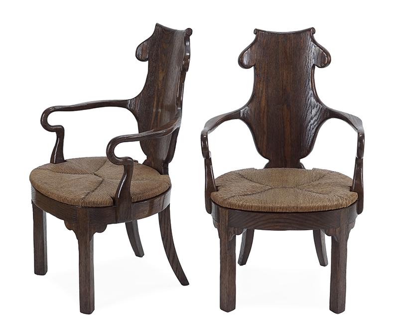 A Pair of English Carved Oak Armchairs.: A Pair of English Carved Oak Armchairs. Bearing rush seats 40 1/2" x 24 1/2" x 21"
