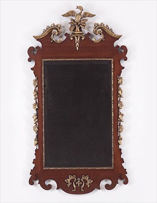 A Chippendale Style Mirror.: A Chippendale Style Mirror. 20th century, with a bird at the top and strawberry vines at the sides 48" x 26" x 2"