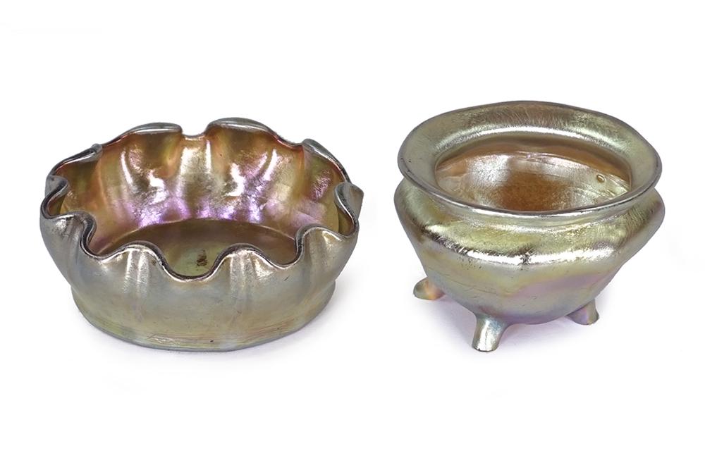 Two Tiffany Studios Favrile Glass Salt Dishes.: Two Tiffany Studios Favrile Glass Salt Dishes. Comprising a salt dish raised on four feet (signed "L.C.T.") and a flat bottom ruffled edge salt cellar which is signed "L.C.T. Favrile" on the underside