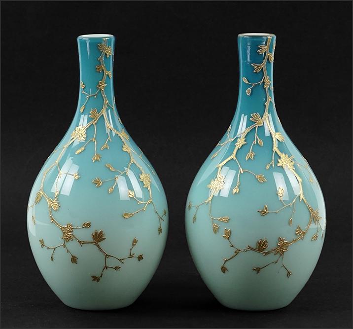 A Pair of Cased Glass Vases.: A Pair of Cased Glass Vases. Blue cased glass bottle form vases with gilt decoration of tree branches. In the style of Thomas Webb, unsigned Height: 9 1/2"