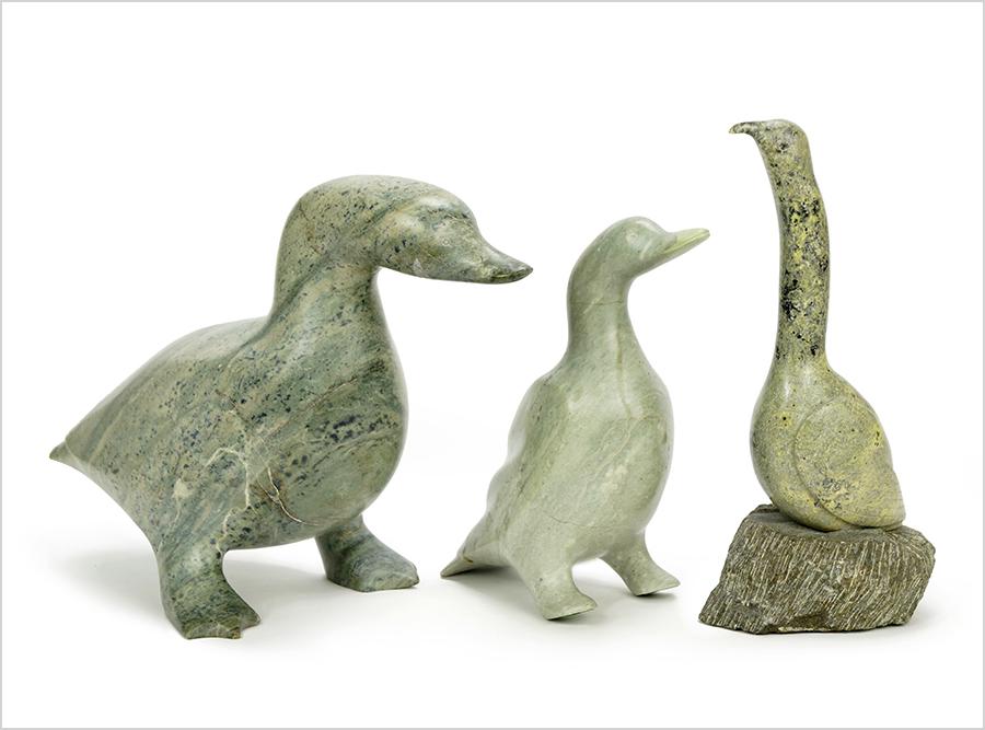 Three Inuit Carved Stone Birds.: Three Inuit Carved Stone Birds. Comprising two geese, both numbered on the underside and a bird mounted to a rock base (overall: 11") Larger stone goose: 12 1/2" x 7" x 9"