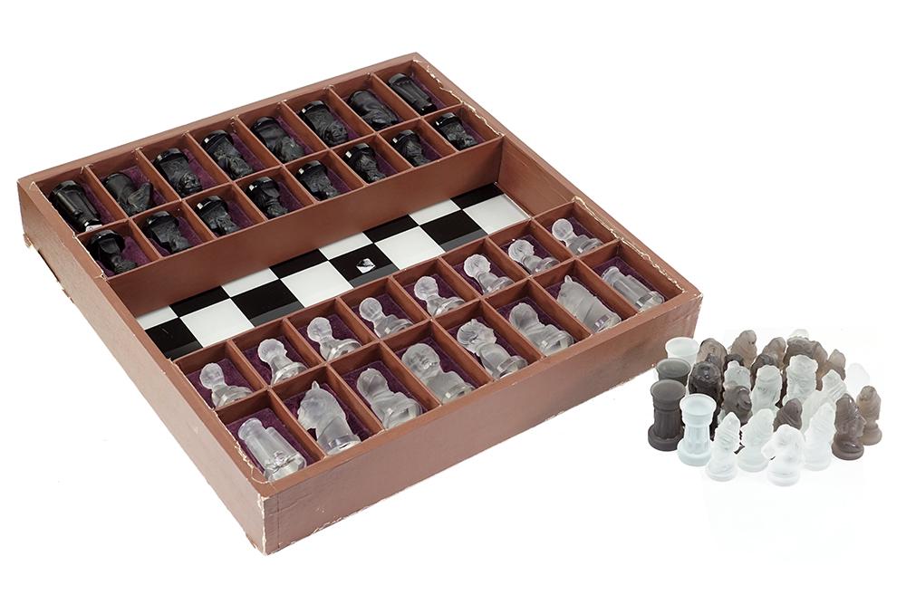 A Frosted Glass Chess Set.: A Frosted Glass Chess Set. Frosted pressed glass playing pieces and glass chess board fit into original presentation box. Together with a partial set of frosted glass chess pieces (lacking three clear