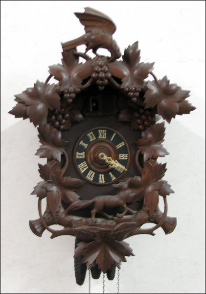GERMAN OAK CUCKOO CLOCK.: GERMAN OAK CUCKOO CLOCK. H: 25" W: 18" D: 10"