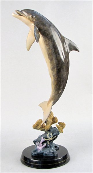 ROBERT WYLAND (B. 1956) CAST BRONZE DOLPHIN.: ROBERT WYLAND (B. 1956) CAST BRONZE DOLPHIN. Edition 443/2000. Signed "Wyland 1999". Raised on 2" marble base Height without bases: 29" x 7"