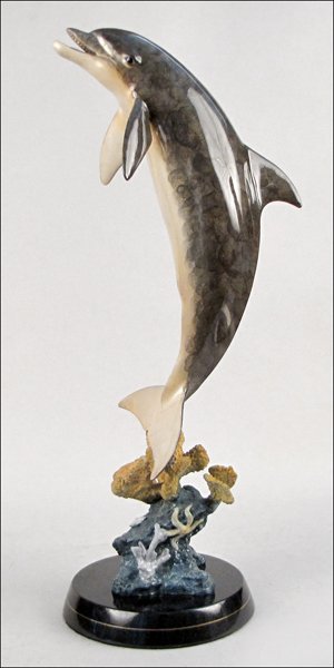 ROBERT WYLAND (B. 1956) CAST BRONZE DOLPHIN.: ROBERT WYLAND (B. 1956) CAST BRONZE DOLPHIN. Edition 429/2000, signed "Wyland 1999". Raied on a 2" marble base 29" x 7"