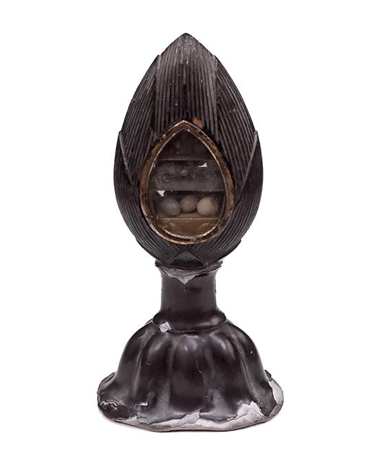 A Buddhist Sharito Reliquary.: A Buddhist Sharito Reliquary. Possibly 17th century, lacquered carved wood in the form of a lotus flower, containing small pebbles separated by two metal dividers on the interior Height: 4 1/2"