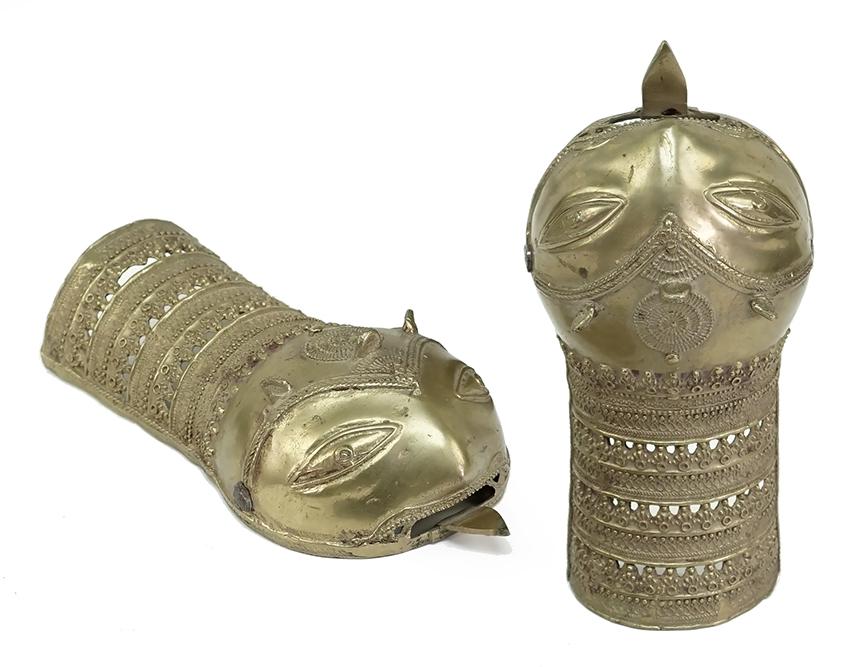 A Pair of Indian Bronze Gauntlet / Pata.: A Pair of Indian Bronze Gauntlet / Pata. Bronze hand covers in the form of a mask with protruding tongue / dagger. With hand bars on the interior 9 3/4" x 4 1/2"