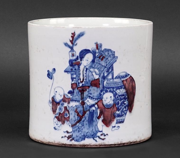 A Chinese Blue and White Porcelain Brush Pot.: A Chinese Blue and White Porcelain Brush Pot. With underglaze copper red accents, decorated with figures, and bearing an underglaze blue six-character Kangxi mark on the underside 7" x 7 1/4"